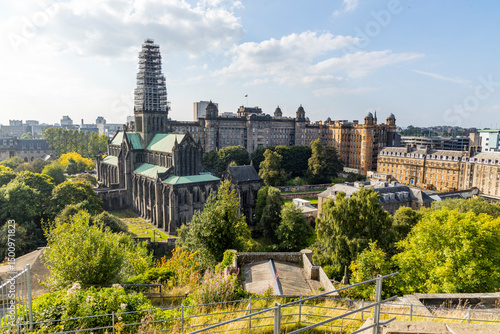 Glasgow cityscape in Scotland, where historic buildings meet modern architecture. The River Clyde flows through the heart of the city, crossed by iconic bridges and surrounded by vibrant urban life.