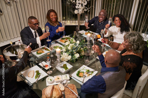Fotografie Group of friends having dinner while celebrating silver wedding anniversary