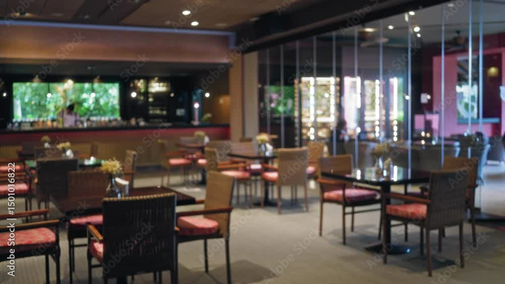 Elegant restaurant interior with blurred view of tables, chairs, and defocused bartender in the background, featuring modern decor and a cozy atmosphere. Elegant restaurant interior with blurred view of tables, chairs, and defocused bartender in the background, featuring modern decor and a cozy atmosphere.
