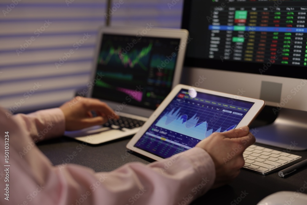 Stock exchange. Woman working in office at night, closeup Stock exchange. Woman working in office at night, closeup