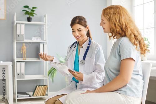 Bild auf Leinwand Young doctor woman holding report file with appointment and prescribe treatment to a female sick patient sitting in clinic during medical examination
