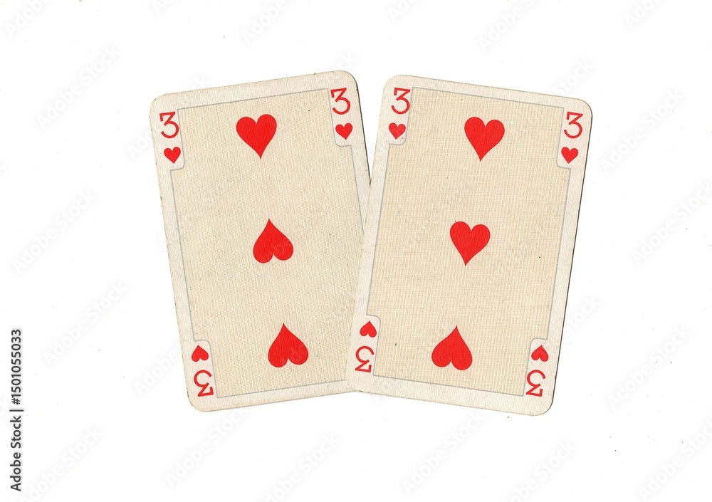 Obraz premium A pair of identical vintage playing cards isolated on a white background.