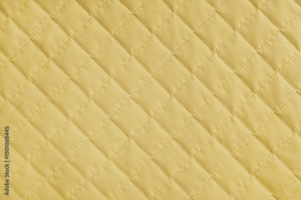 Fototapeta premium Checkered, diamond stitching pattern, yellow quilted fabric background. Blanket or puffer jacket, stitch rhombus texture close up, macro. Wallpaper, backdrop.
