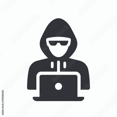 Anonymous hacker using laptop with hood and sunglasses in dark setting  