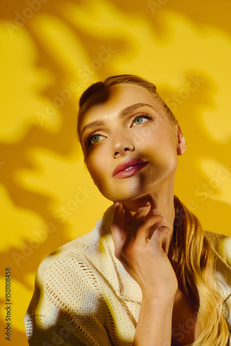 Bild auf Leinwand Captivating portrait of a young woman embracing sunlight and shadows in a vibran
