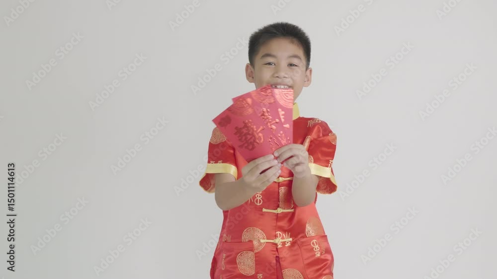 Portrait of an Asian boy in a festive red cheongsam qipao holding an angpao red packet monetary gift. Perfect for Chinese New Year themes, highlighting tradition and blessings. Isolated on white. Portrait of an Asian boy in a festive red cheongsam qipao holding an angpao red packet monetary gift. Perfect for Chinese New Year themes, highlighting tradition and blessings. Isolated on white.