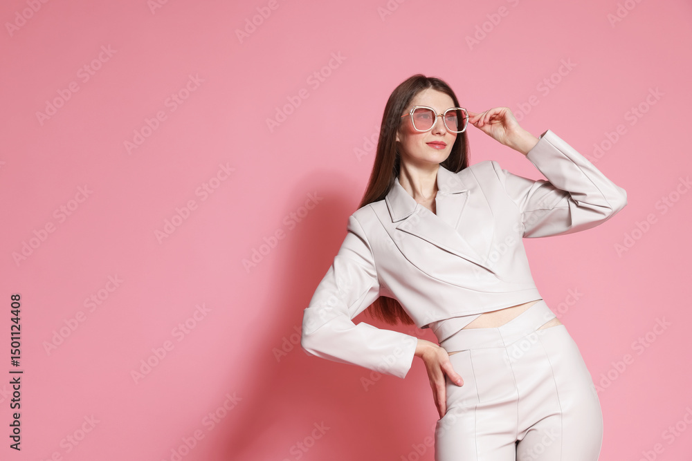 Fashionable portrait of beautiful woman in stylish outfit on pink background. Space for text Fashionable portrait of beautiful woman in stylish outfit on pink background. Space for text