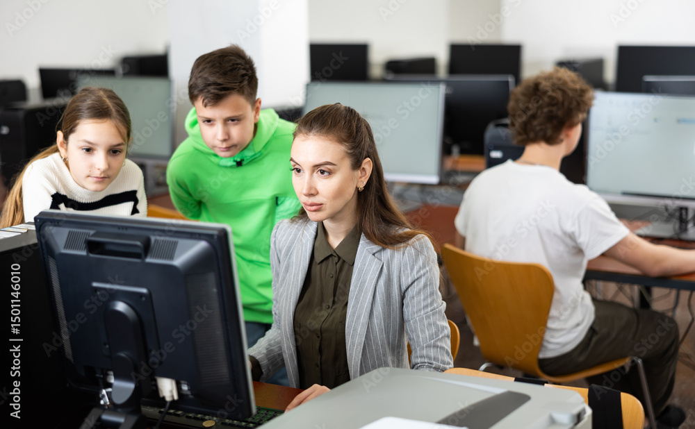 Fototapeta premium Teacher helping young student in computer class in university
