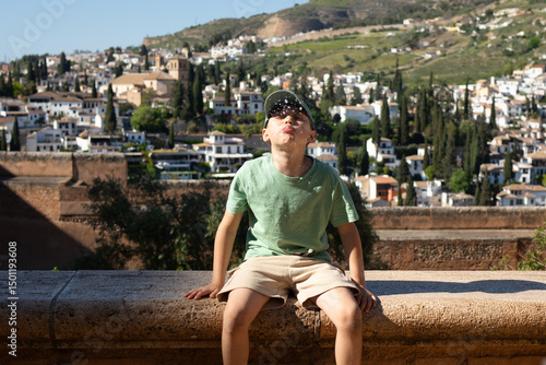 Konstfotografi Young boy spitting water in summer day