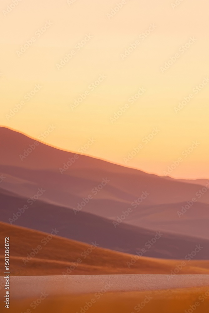 Naklejka premium Serene desert landscape at sunset, showcasing rolling hills and a tranquil road. Evokes feelings of peace, adventure, and the beauty of nature.