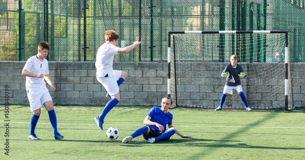 Obraz premium Teens playing soccer football match. Competition between two youth soccer teams. Football soccer tournament