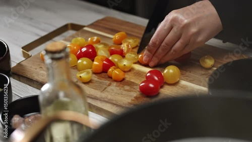 Female Chef Slicing Cherry Tomatoes with Sharp Knife.