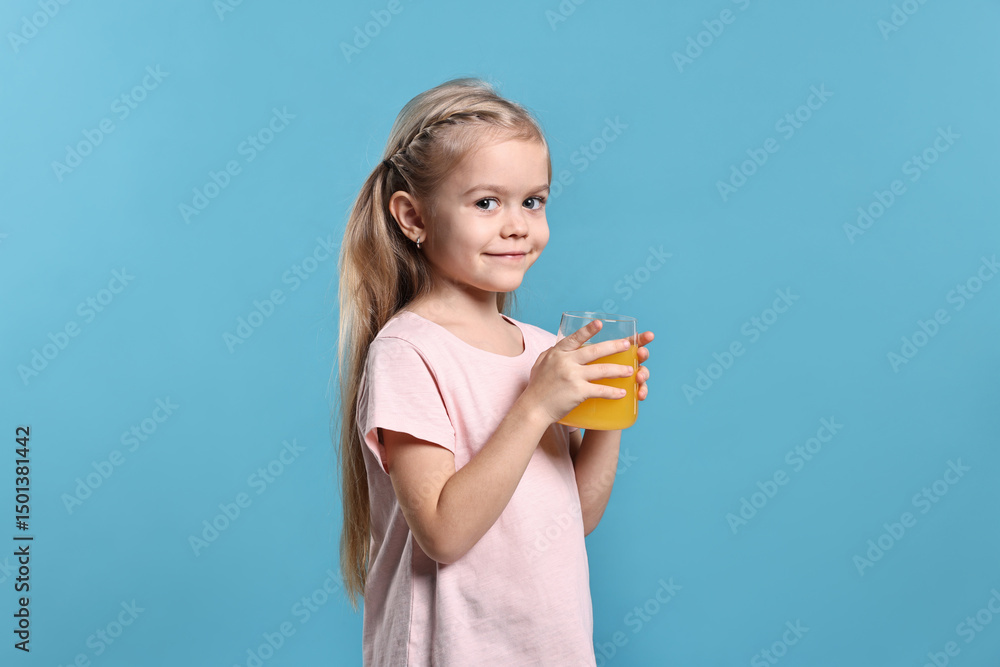 Girl with glass of orange juice on light blue background. Refreshing drink Girl with glass of orange juice on light blue background. Refreshing drink