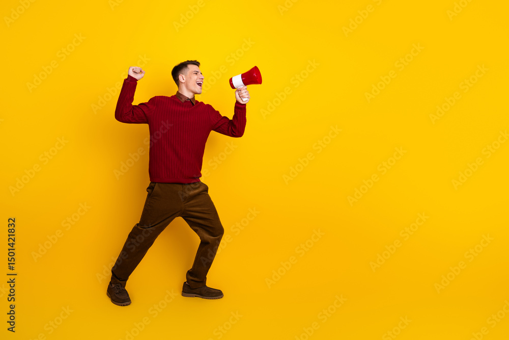 Young Man with Megaphone Against Bright Yellow Background Expressing Excitement and Energy Young Man with Megaphone Against Bright Yellow Background Expressing Excitement and Energy