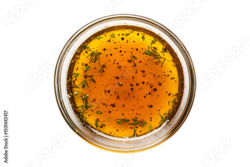 Top view of a small glass bowl filled with homemade herb vinaigrette dressing.  Perfect for salads, marinades, or dipping.