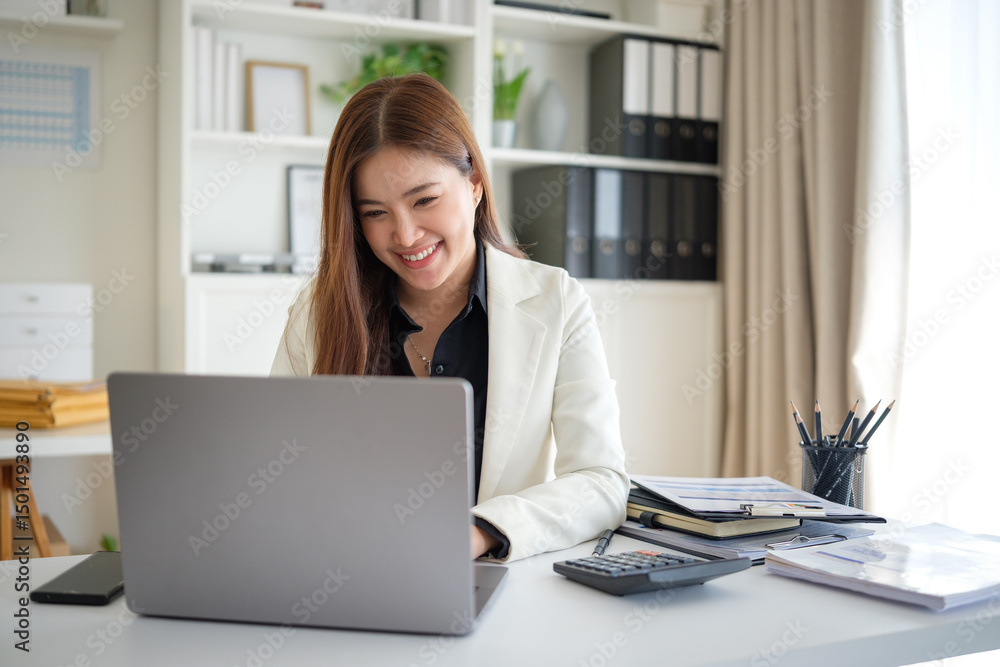 Confident young woman in formal attire engaging with work tasks on a laptop, reflecting a positive and productive professional atmosphere. Confident young woman in formal attire engaging with work tasks on a laptop, reflecting a positive and productive professional atmosphere.