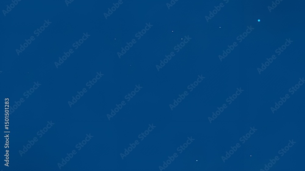 Fototapeta premium Uniform deep blue background with subtle specks.