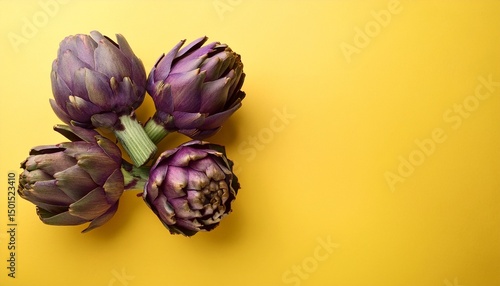 raw purple artichokes on light yellow background top view fresh vegetables for vegetarian diet
