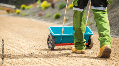 фотографія Worker Using a Wheelbarrow to Transport Materials on a Construction Site in Brig