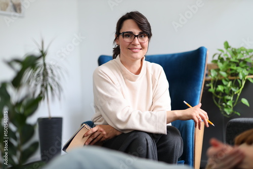 Bild auf Leinwand Young caucasian female therapist with glasses in office setting
