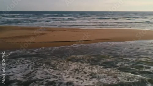 Coastal Serenity Gentle Waves Lap Golden Shoreline At Sunrise