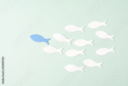 Blue fish is leader of group, working as a team, new ideas, goals, plans and strategy for success, teamwork concept