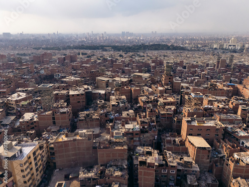 Wallpaper Mural Aerial view of the bustling urban landscape of Mansheya Nasir, The Garbage City with crowded rooftops and dense buildings, Manshiyat Nasser, Cairo, Egypt. Torontodigital.ca
