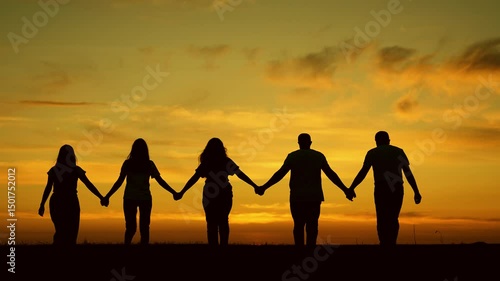 Unity of group of people united by team idea. Team of people look at their future together at sunset, park. Human resources. Group of business person outdoor. Community of people joint prayer, sunset