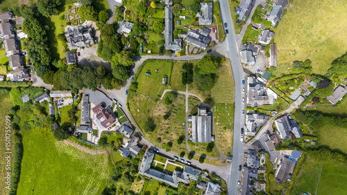 Aerial view of Milton Abbot featuring St. Constantine's Church amidst beautiful greenery and residential buildings, Tavistock, United Kingdom.