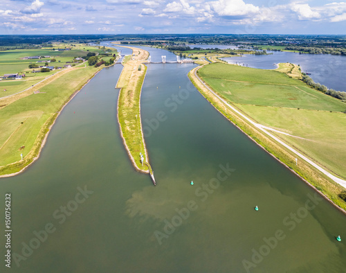 Aerial view of river Nederrijn with weir and lock complex between Amerongen and Maurik, border between provinces of Utrecht and Gelderland, Netherlands.