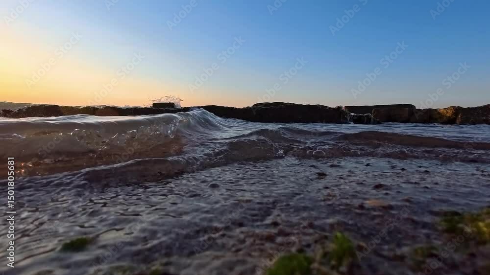 Surf at the rocks at sunset, view from the water level. Surf at the rocks at sunset, view from the water level.