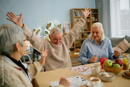 Fotografía Group of elderly friends enjoying each other's company while playing a board gam