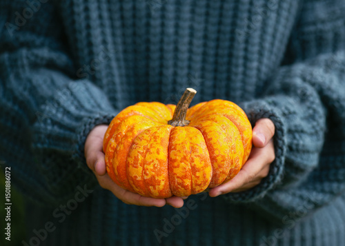 Young girl holding ripe organic orange 