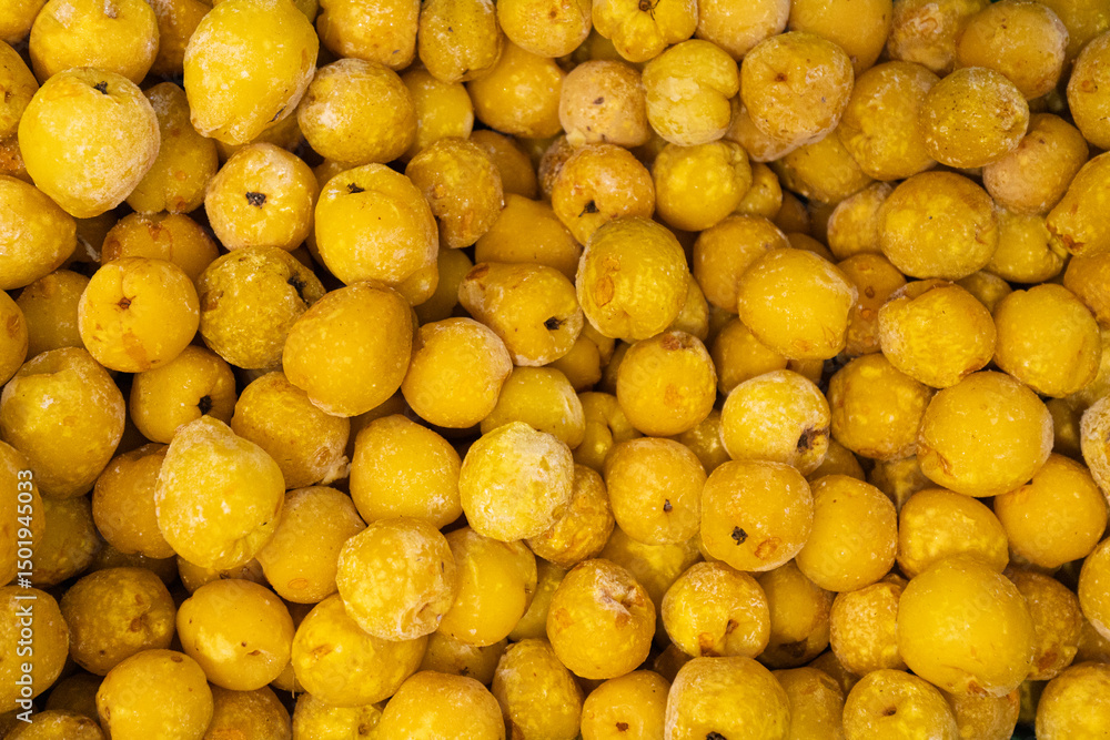 A close-up image showing chopped frozen quinces in various sizes, highlighting their yellow color and icy texture, ideal for culinary use. A close-up image showing chopped frozen quinces in various sizes, highlighting their yellow color and icy texture, ideal for culinary use.