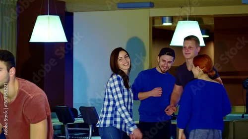 Excited friends celebrate at the bowling alley