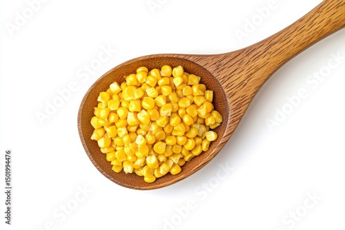 Corn kernels in a wooden spoon isolated on white background