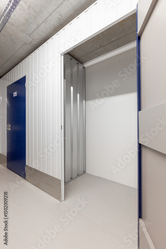 Open empty self-storage unit with a view into the clean interior