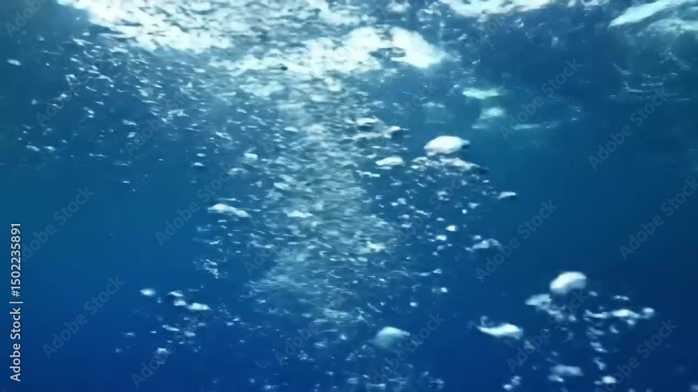 Sunlit Bubbles Rising in Deep Blue Sea – Underwater Close-Up Sunlit Bubbles Rising in Deep Blue Sea – Underwater Close-Up