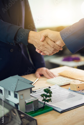 Businessman, house and condo sales representative Hand over the keys to the customer and sign the sales or rental contract according to mutual agreement in the office. Real estate business concept