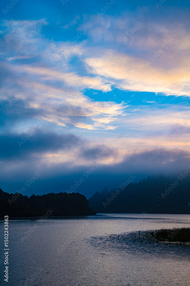 Obraz premium Foggy river sunset