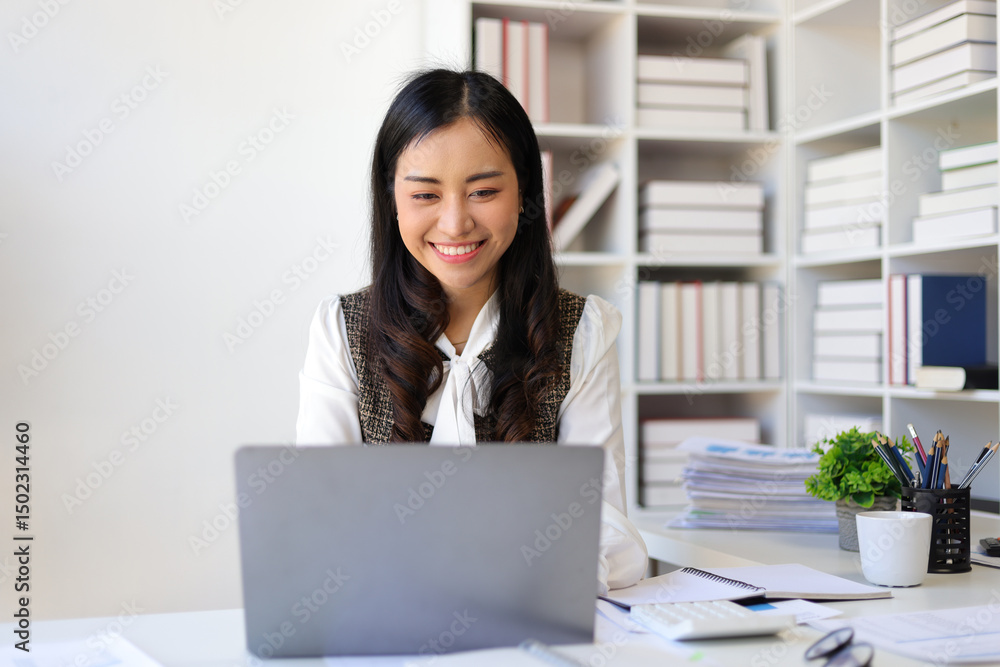 Happy Asian businesswoman smiling and working in the office. Happy Asian businesswoman smiling and working in the office.