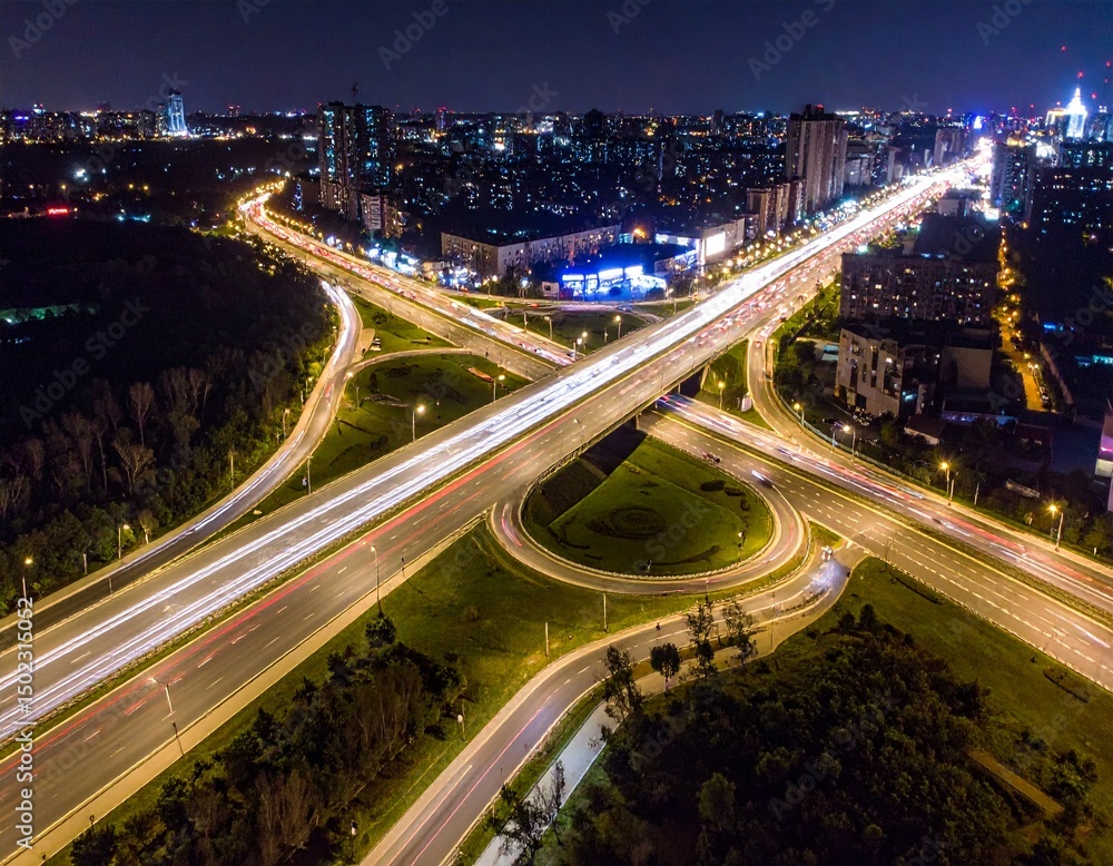 Fototapeta premium Aerial Night View of Illuminated Highway Interchange in City