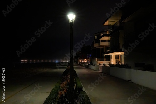 Εκτύπωση καμβά An evening walk along a beach front boardwalk with houses, sea air and beach fea