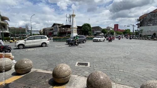 Iconic Tugu Monument in Yogyakarta, Indonesia with Passing Traffic – Midday Shot
