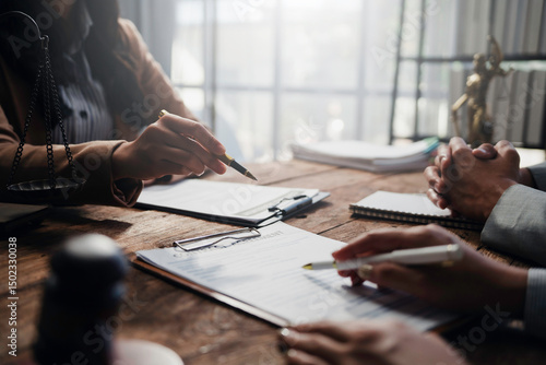 Lawyers and clients engaging in a detailed discussion about contract specifics during a focused meeting in a professional law office