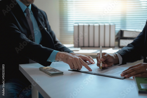 Schilderij op canvas Businessman bribing another businessman with cash while signing a contract, high