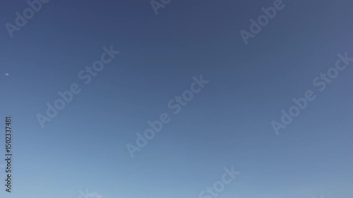 Time lapse of moving white clouds with blue sky background