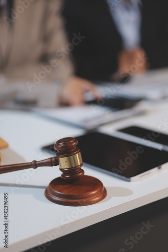 Judge gavel with Justice lawyers having team meeting at law firm background. Concepts of Law and Legal services.