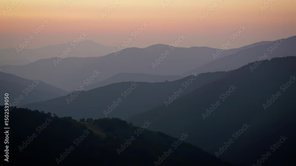 Serene sunset over rolling hills, creating a hazy, layered landscape. Serene sunset over rolling hills, creating a hazy, layered landscape.