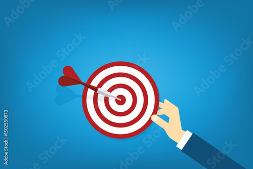 Hand holding a target, showing a goal. Red arrow hits the center. Business challenge failure and success concept.	